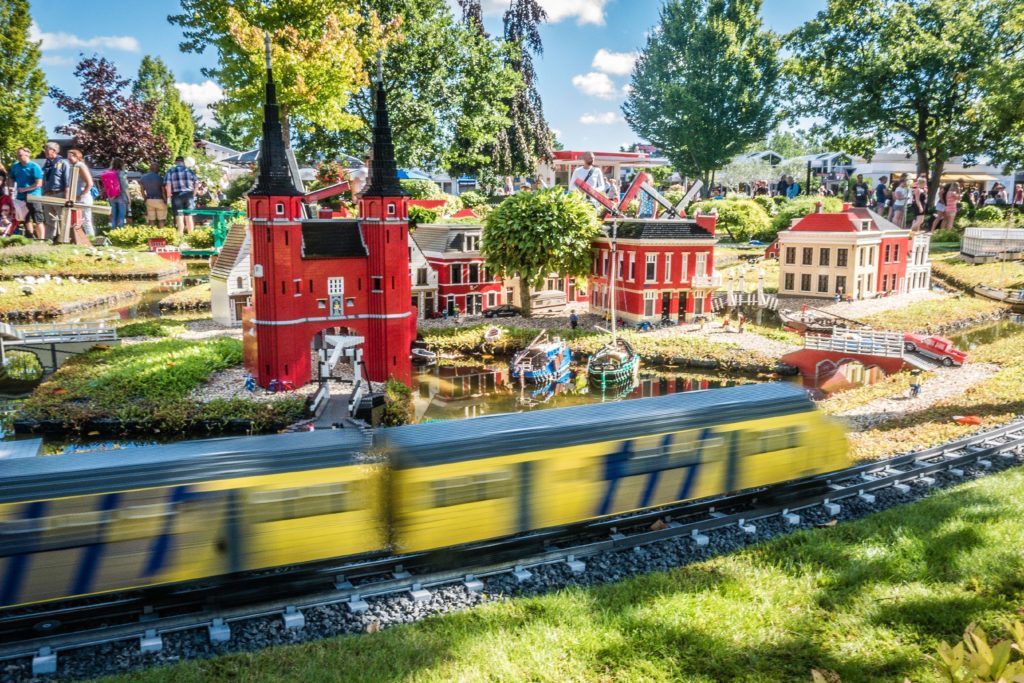 Photo of a model goods train passing through Miniland at Legoland Billund. 