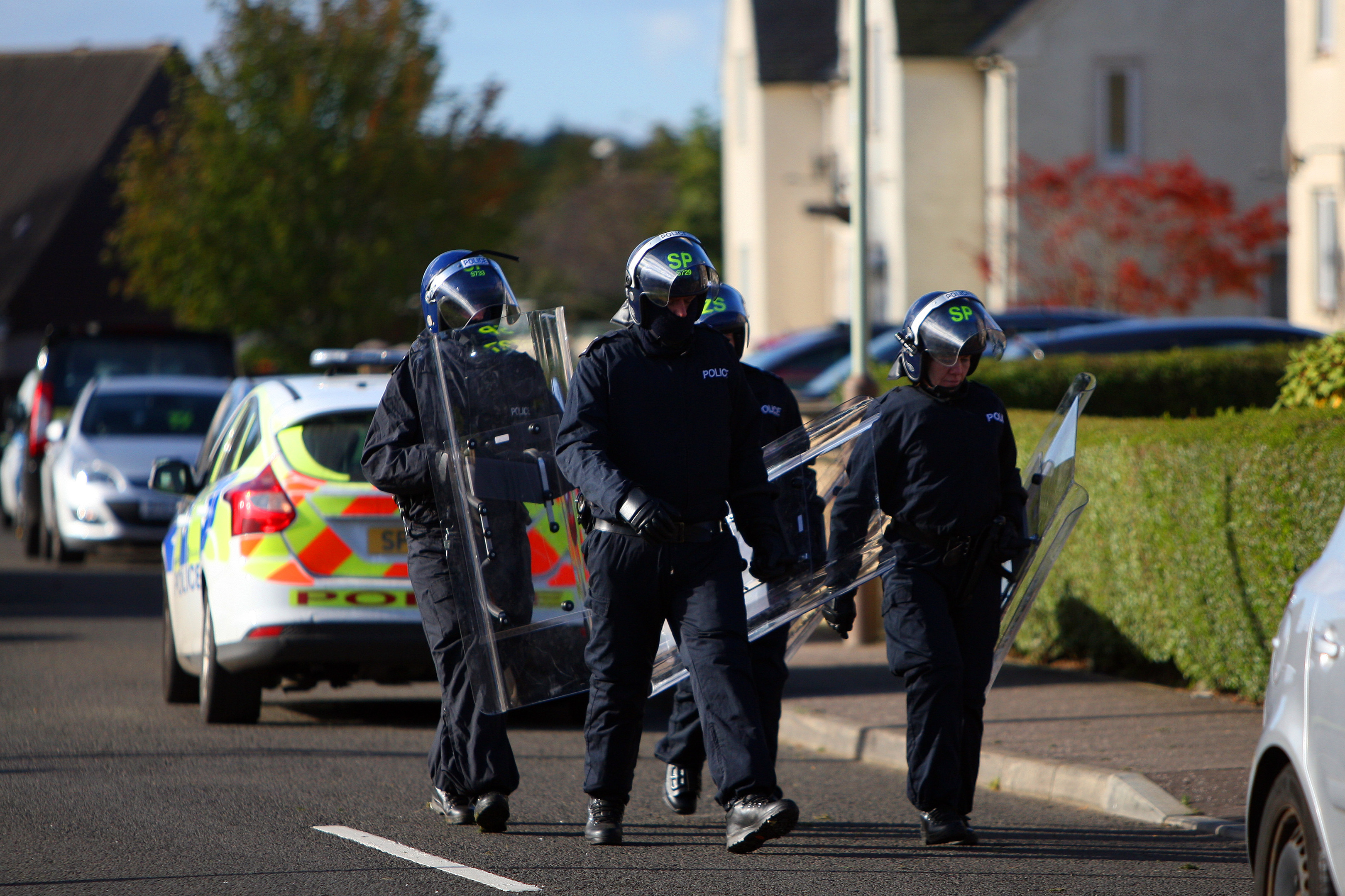 Riot police descend on a property in Wellbank on Sunday morning.