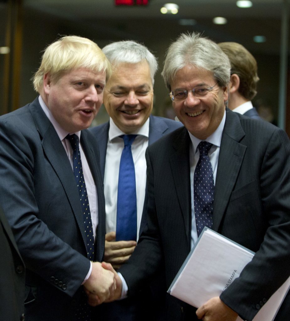 Boris Johnson shakes hands with Italian Foreign Minister Paolo Gentiloni, right, during a meeting of EU foreign ministers at the EU Council building in Brussels.