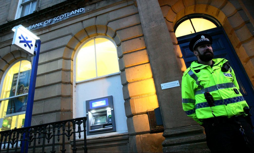 A police officer outside the bank branch on Tuesday.