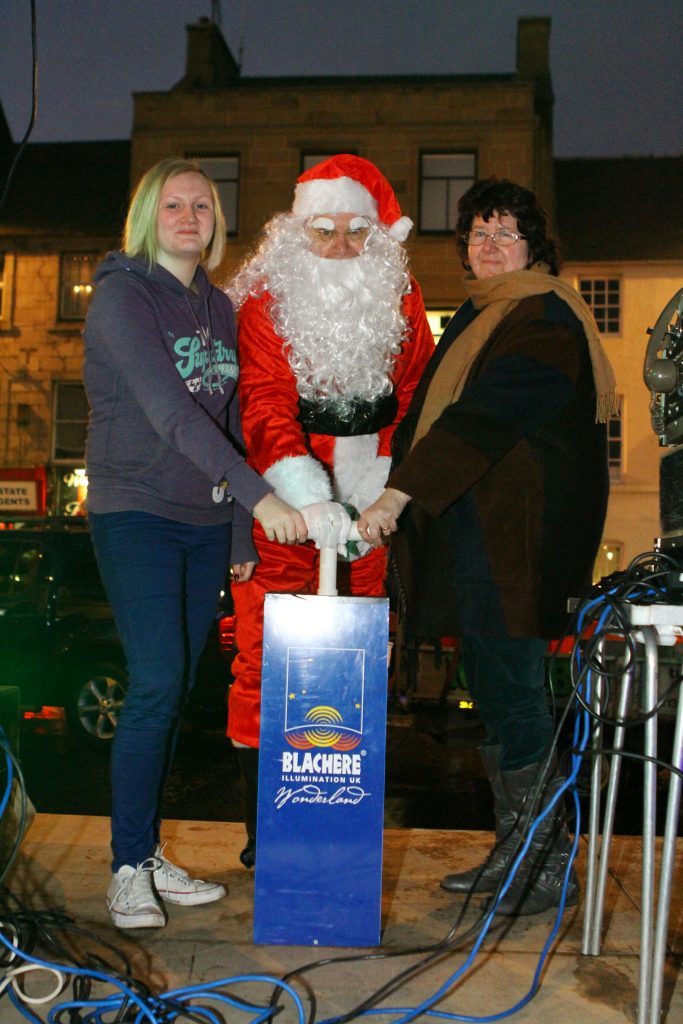 Santa takes the plunge with Alana and Sue in Cupar.