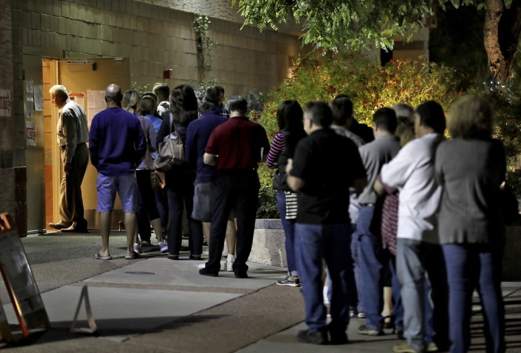 Voters wait in line to vote early in Phoenix.