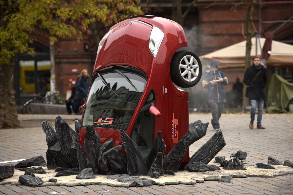 A car 'crashed' into the ground at Hackescher Markt in Berlin, Germany on November 15, 2016, ahead of the launch of Jeremy Clarkson, Richard Hammond and James May's new show, 'The Grand Tour'.