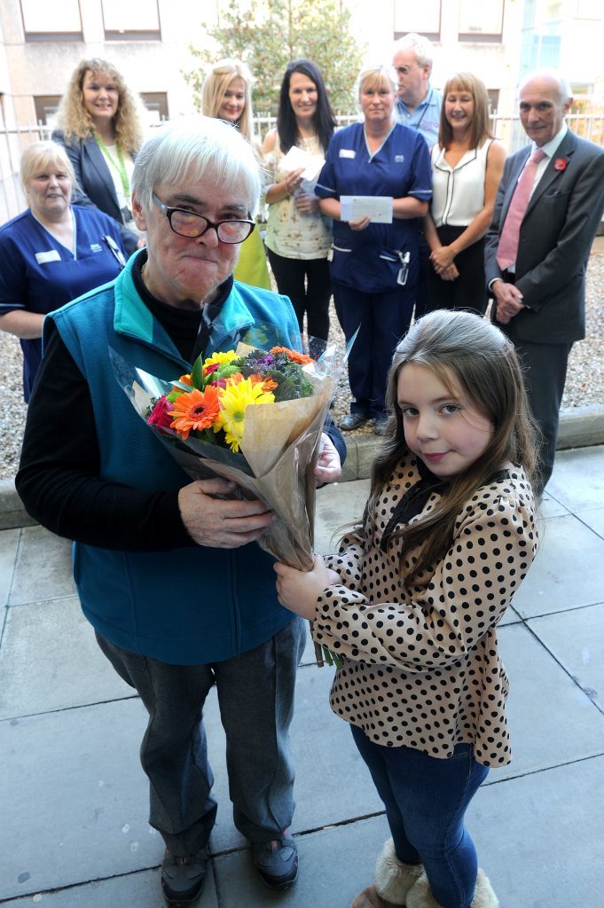 Patricia is presented with a bouquet from Kara Hedley at the Ninewells Hospital Children's Unit.