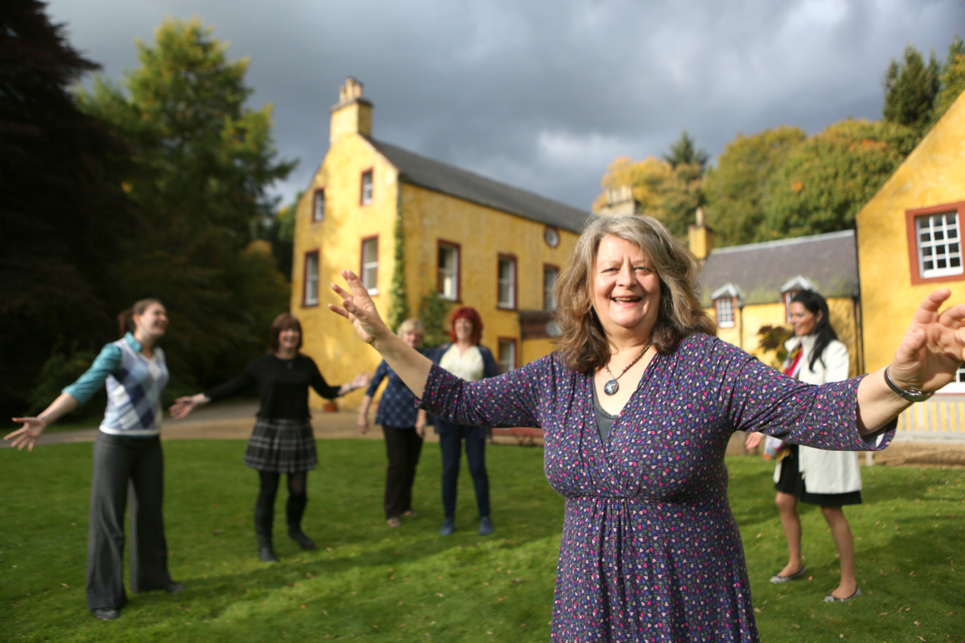 Christine Kydd and Singing for Delight participants outside Balnaboth House in Glen Prosen.
