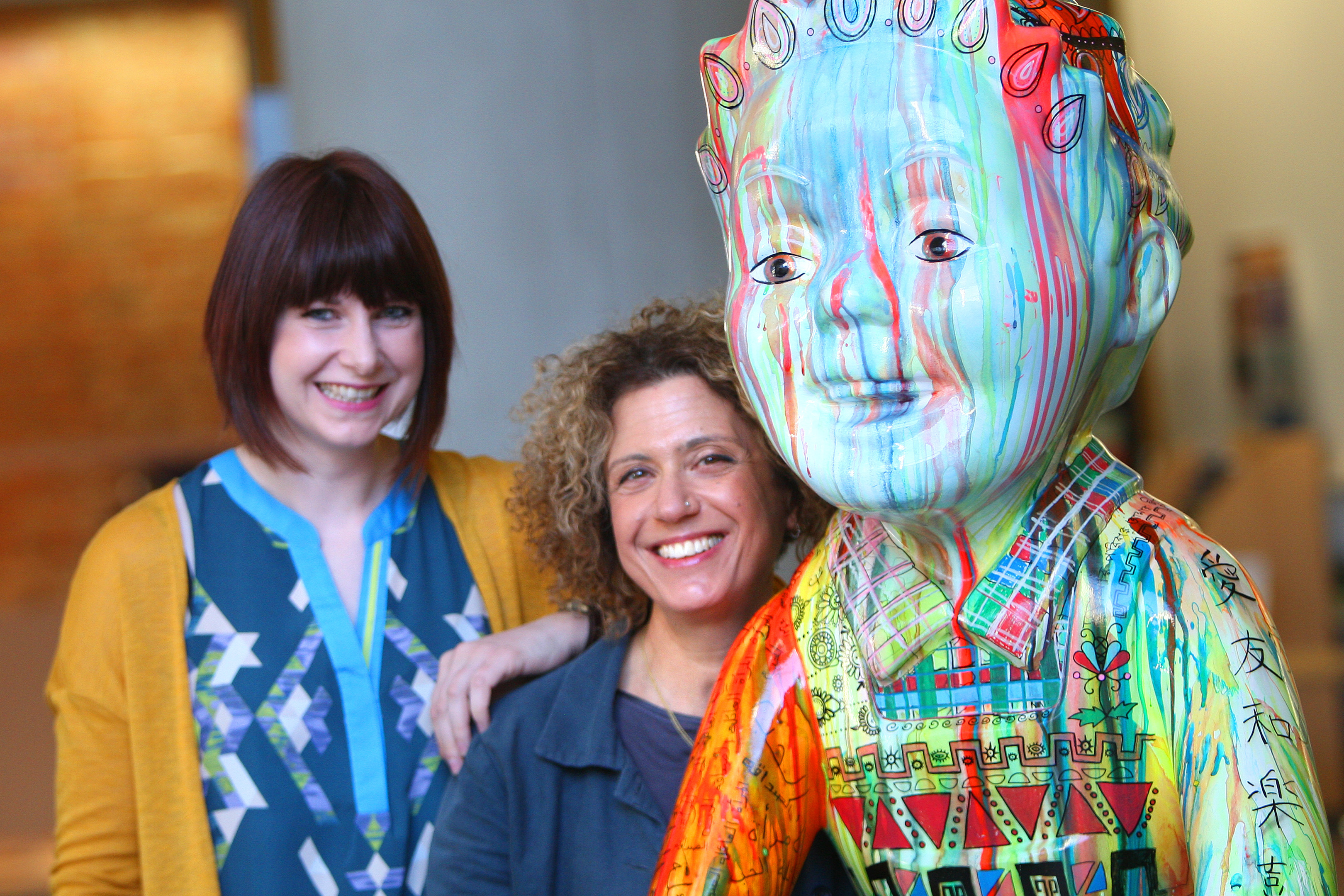 Dundee International Women's Centre illustrator and project support worker Laura Darling and trustee Vered Hopkins welcome the statue to Dundee House.