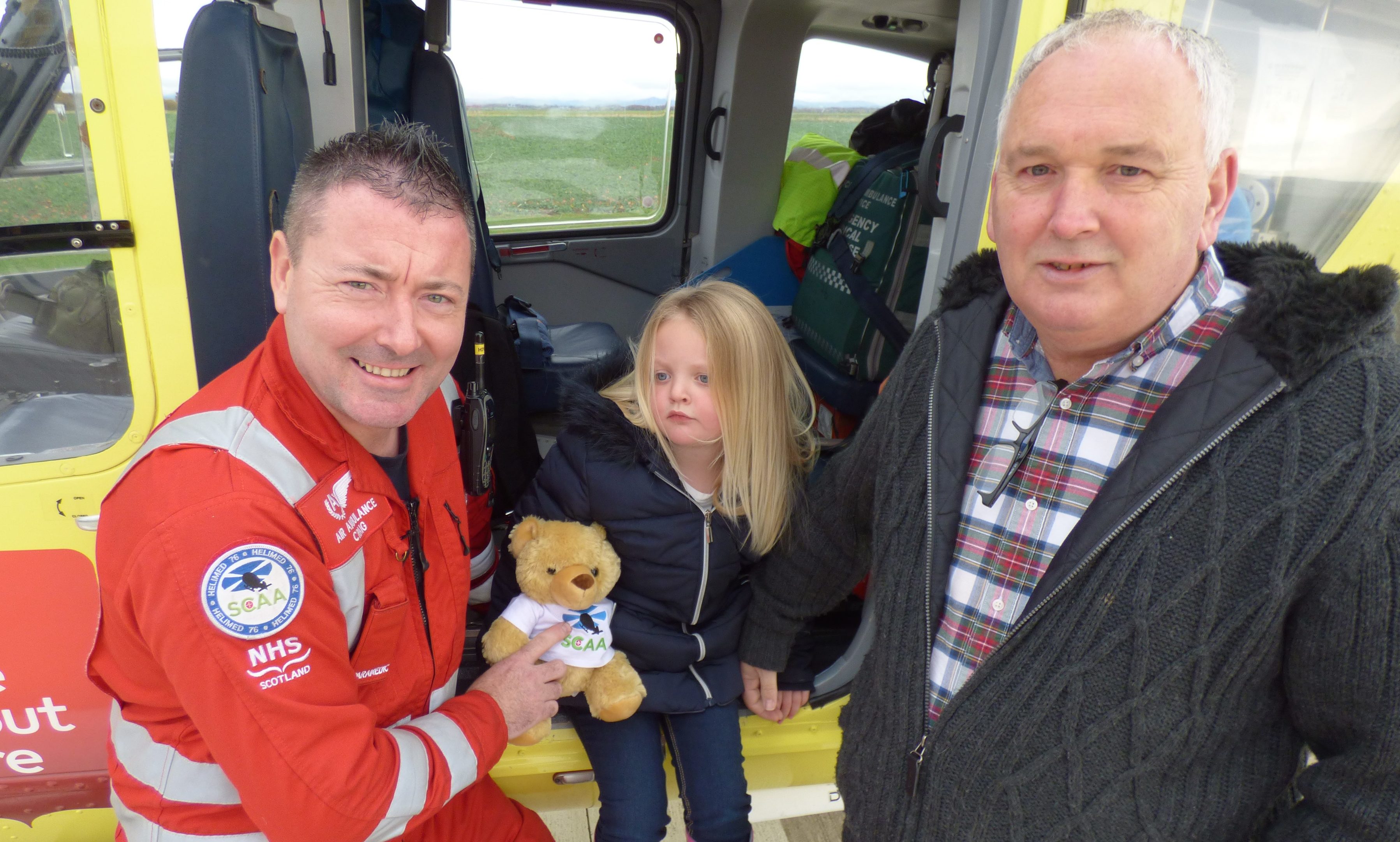 SCAA paramedic Craig McDonald with Robert Fotheringham and granddaughter Kayla, 5.
