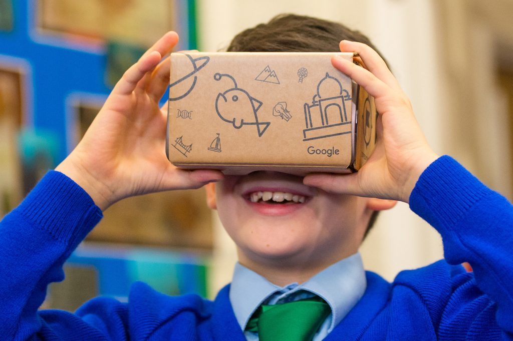 A pupil uses a Google Cardboard VR headset.