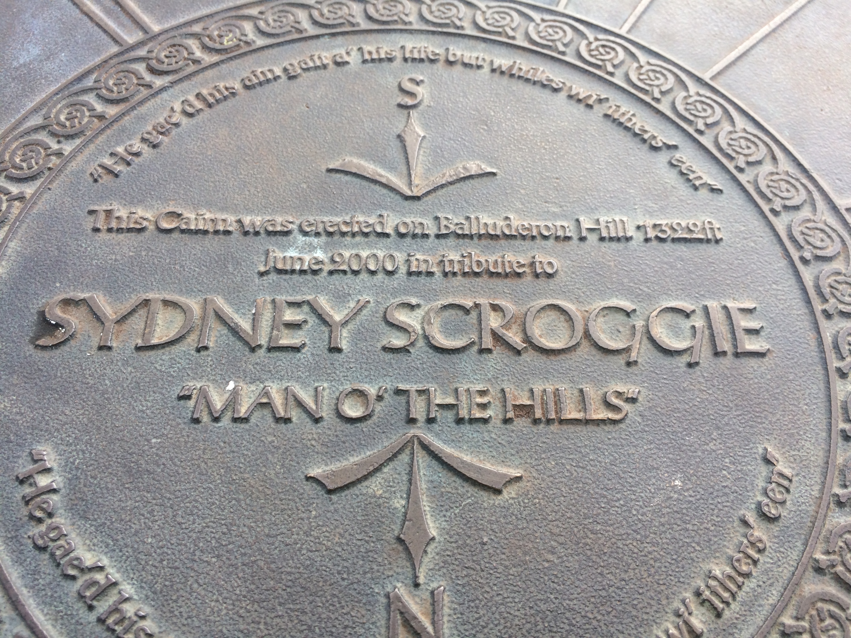 The Syd Scroggie memorial plaque on the top of Balluderon Hill.