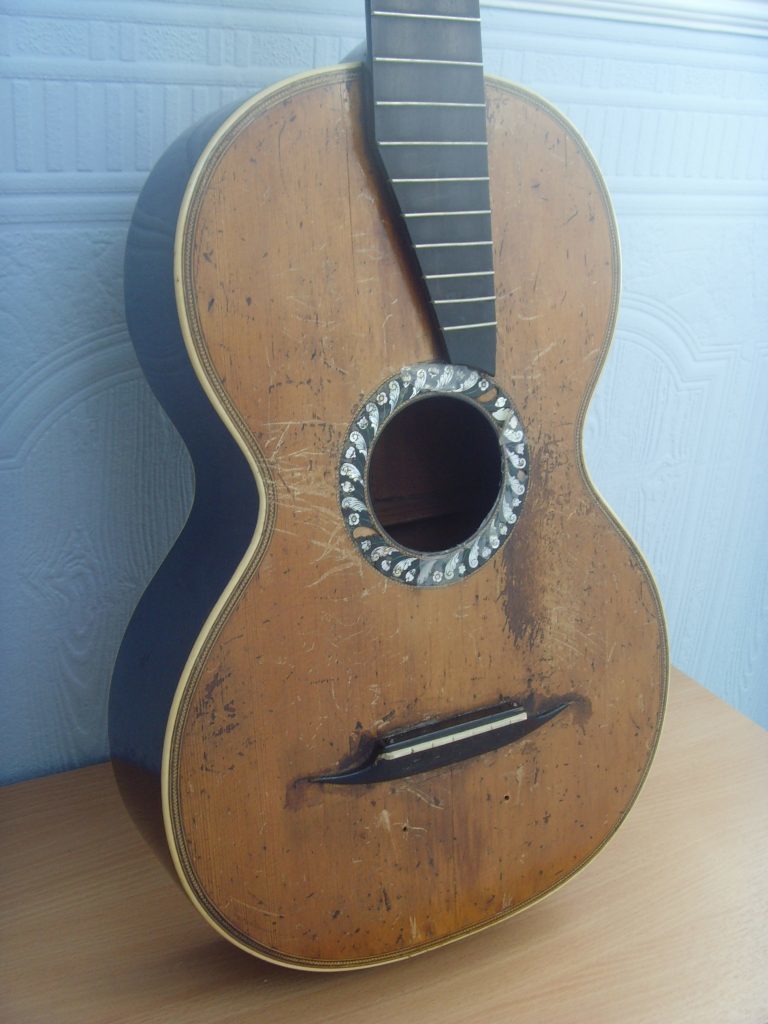 Diana's guitar when it arrived at the workshop.