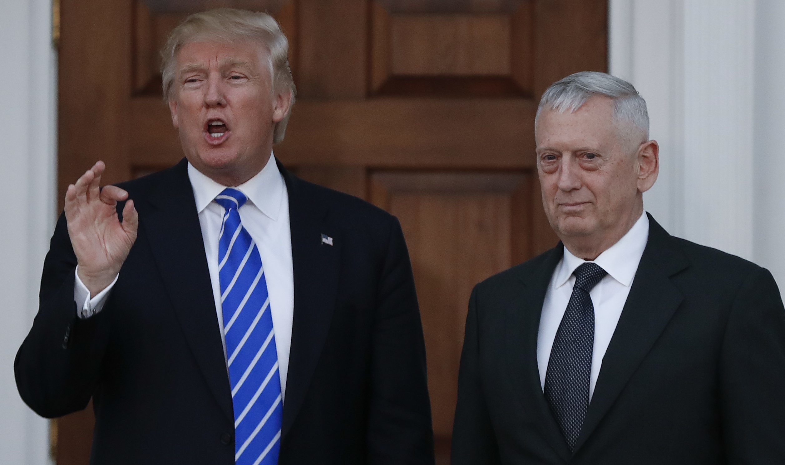 President-elect Donald Trump talks to the media as he stands with retired Marine Corps Gen. James Mattis at the Trump National Golf Club Bedminster clubhouse in Bedminster, N.J.