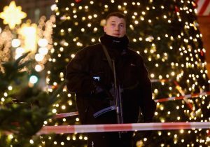 A policeman stands guard at the Christmas market.