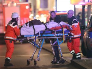 Paramedics remove one of the injured from the scene.