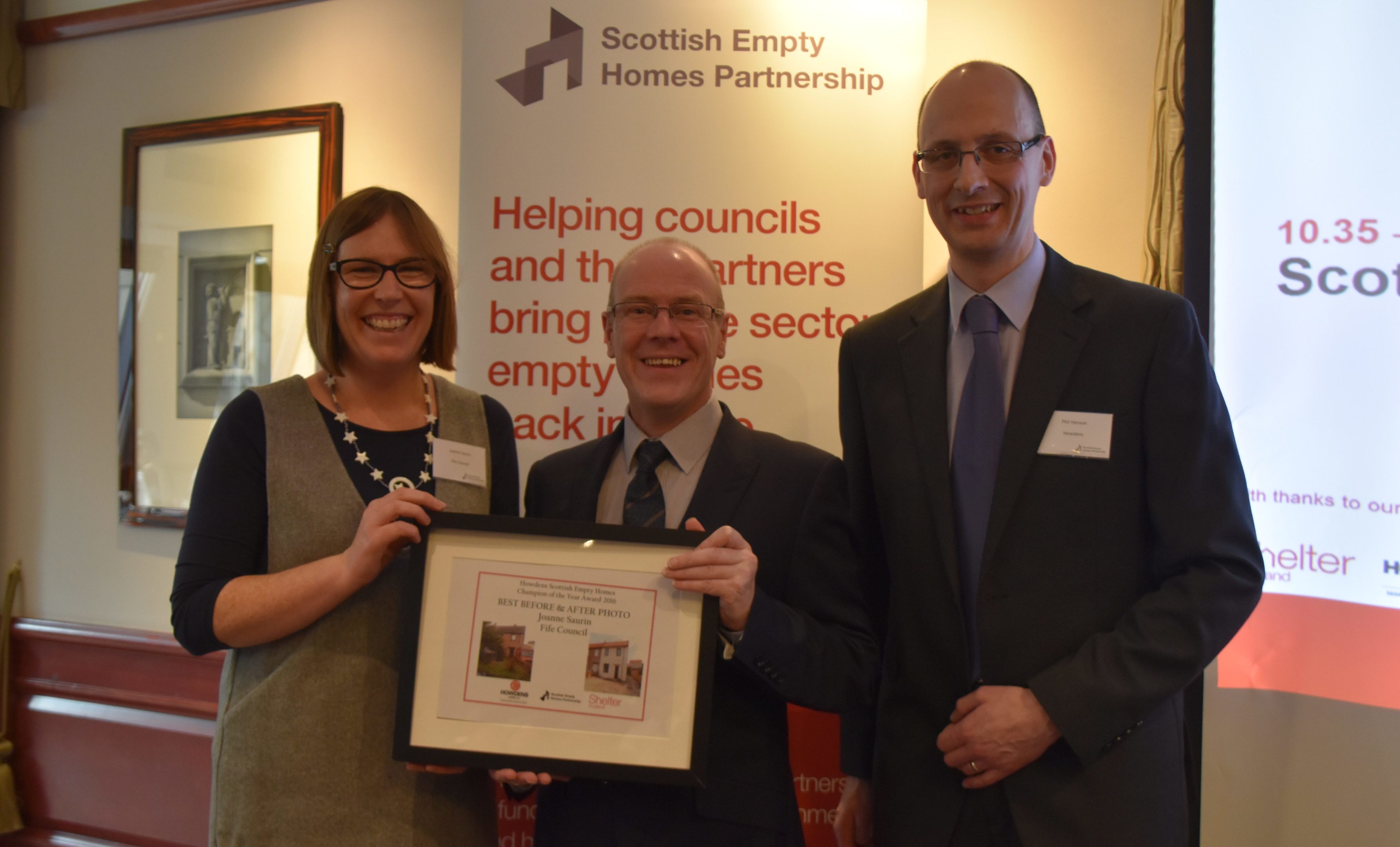Joanne accepts her award from housing minister Kevin Stewart as Philip Hanson, from awards sponsors Howden’s, looks on.