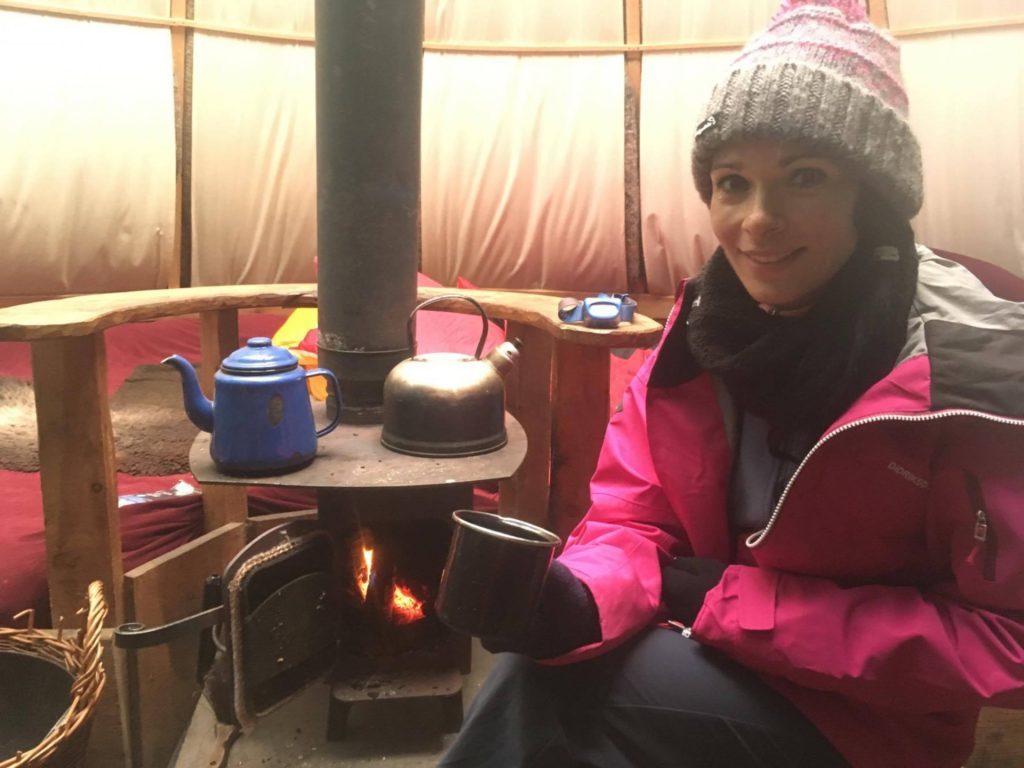 Gayle enjoys coffee inside the cosy kata's wood-burning stove.