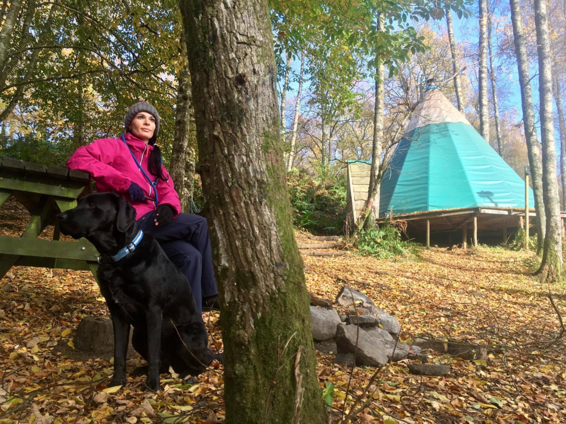 Gayle Ritchie and her dog Toby outside one of Comrie Croft's Nordic katas.