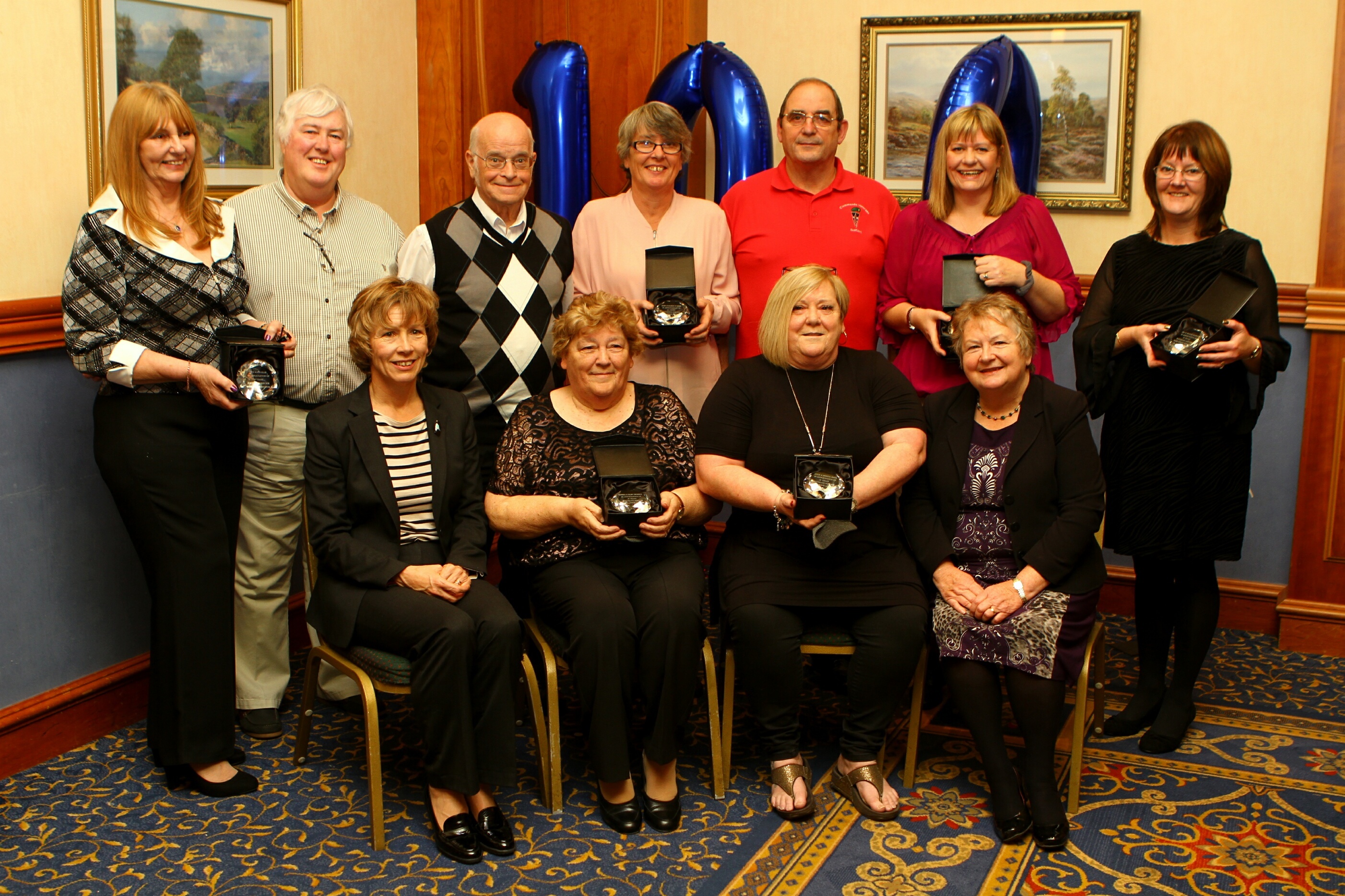 The long service award recipients at the Angus Council Foster Carers annual ceremony. Front L/R: Margo Williamson - Strategic Director, Sheena Thomson, Brenda Smith and Cllr Sheena Welsh - Convenor of Children & Learning. Back L/R: Susan and Rodney Ellis, Allan Thomson, Mary Towner, Colin Smith, Michelle Dewar and Jill Hamilton.