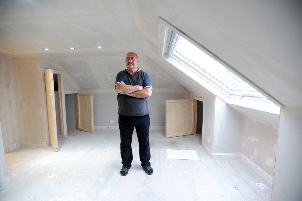 John Fuller in his loft, which has a number of safety and aesthetic issues.