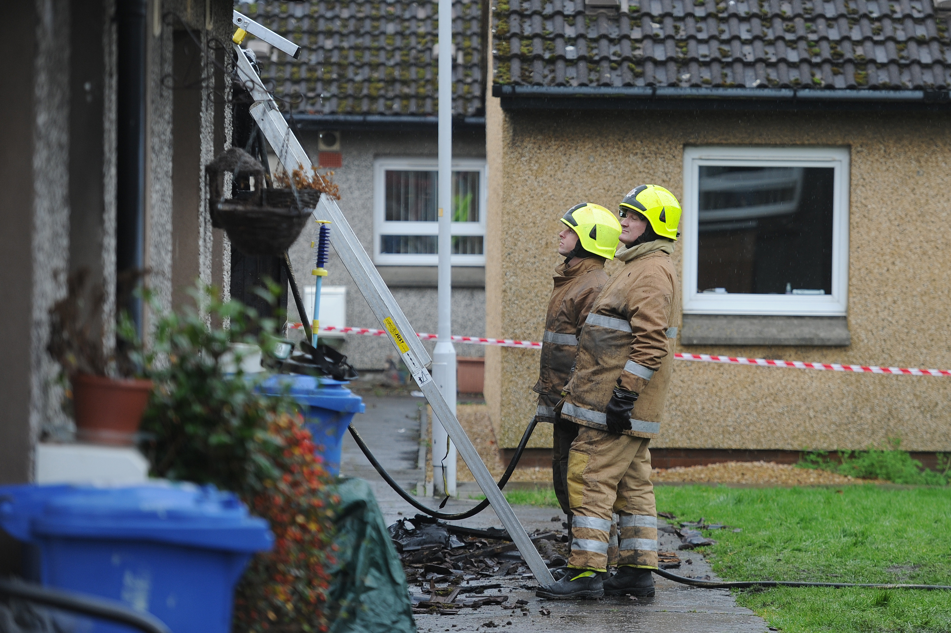 Firefighters who attended the incident at work examining the aftermath.