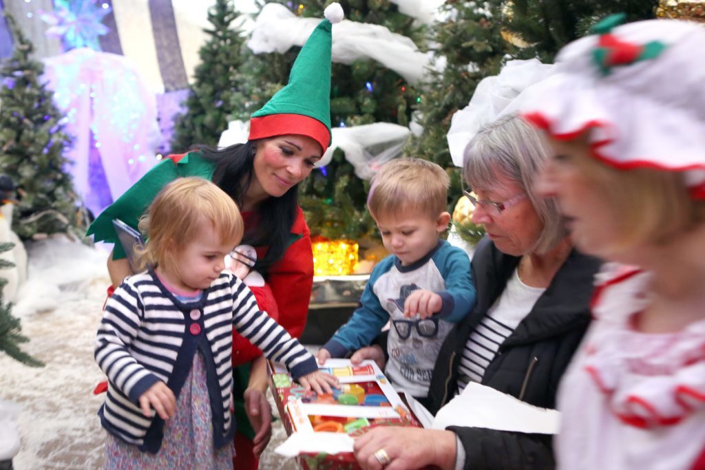 Poppy and Finn Killen open their presents under the watchful eyes of Mrs Claus and their grandmother Jennifer Hall.