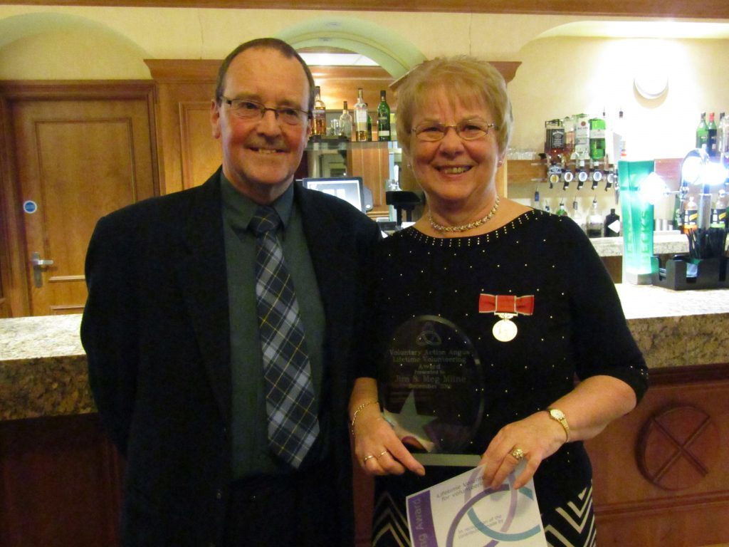 Voluntary Action Angus board member Neil Prentice presented the lifetime volunteering award to Meg Milne to recognise the work of Meg and her husband Jim at the Attic Youth Project in Brechin