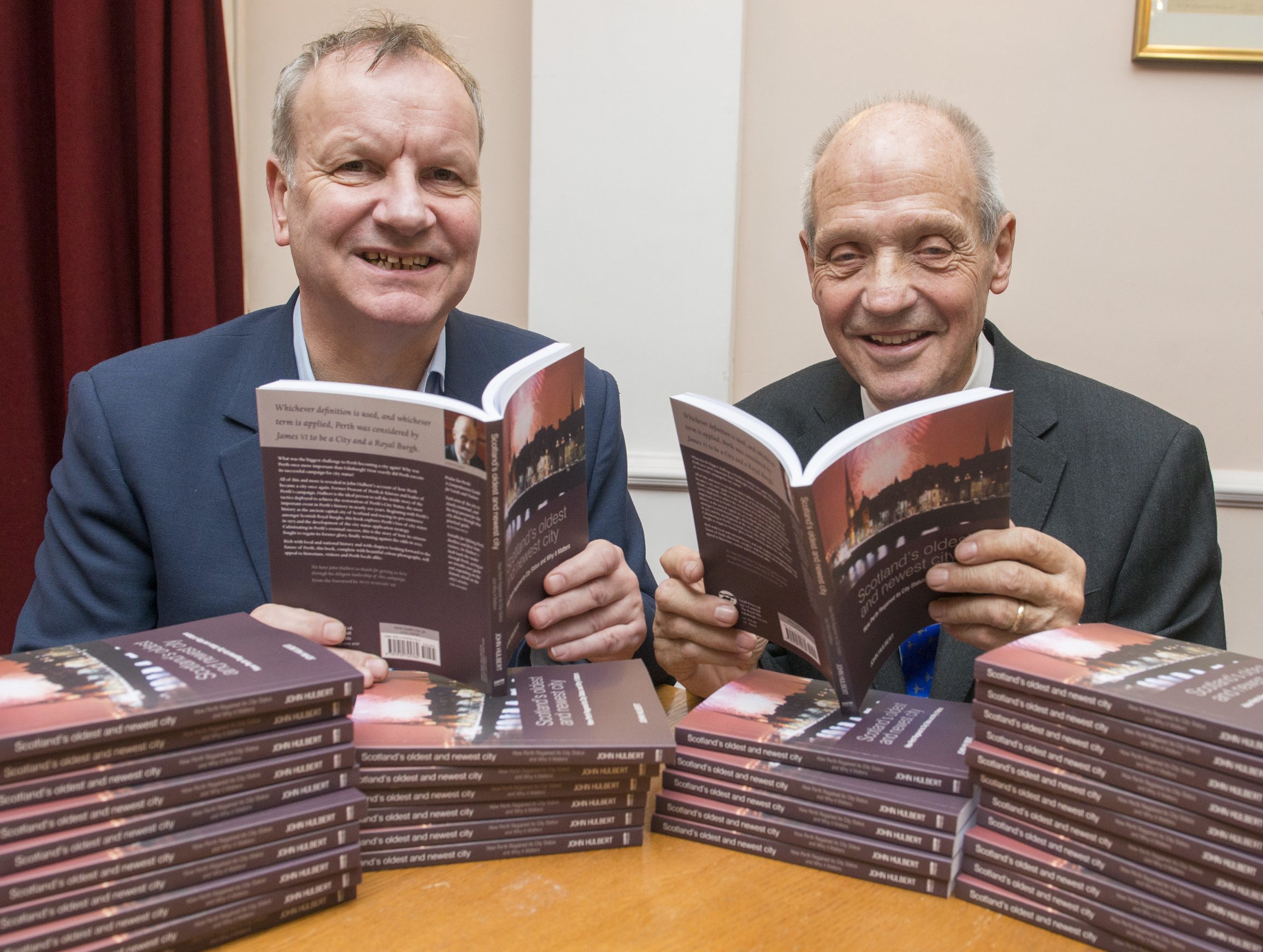 John Hulbert on the right is pictured with his new book and Pete Wishart MP.