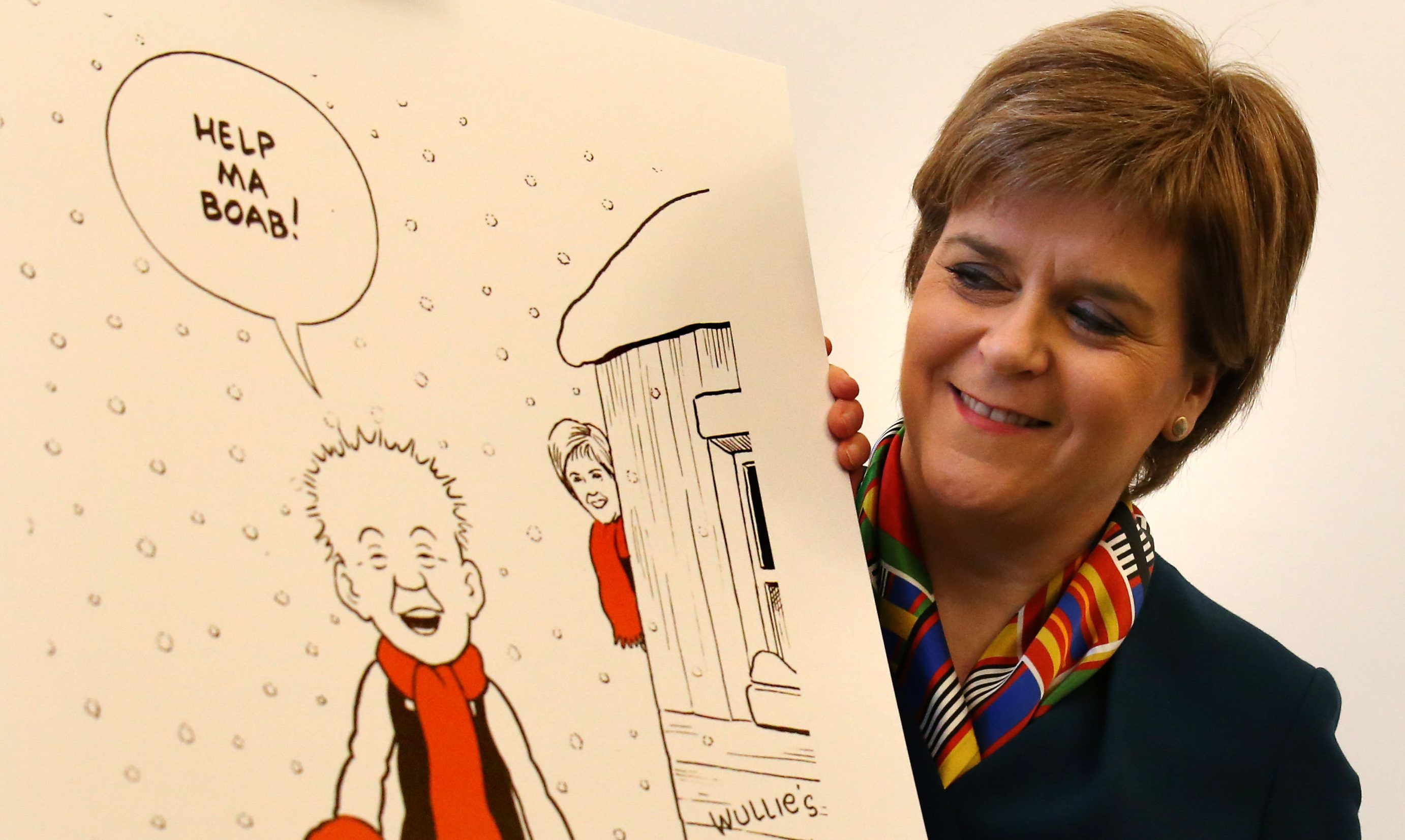 Nicola Sturgeon unveiling her Oor Wullie-themed Christmas card.