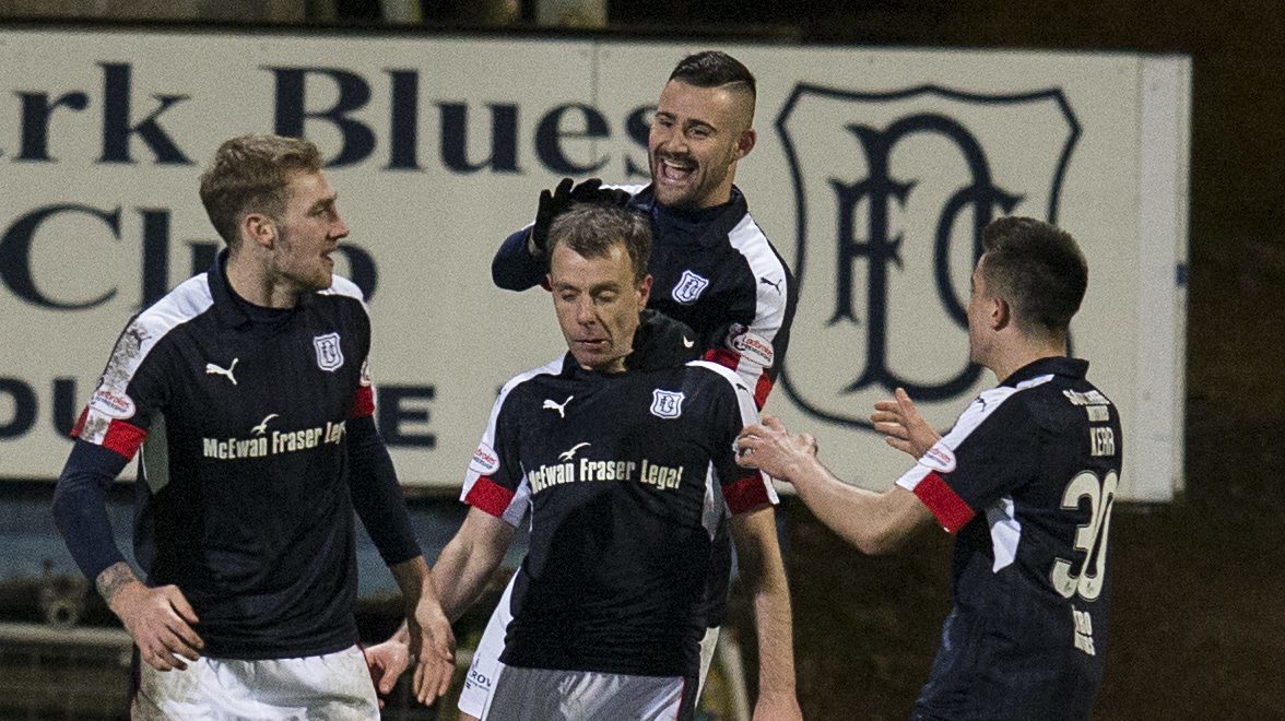 The Dundee players celebrate with Paul McGowan, centre.
