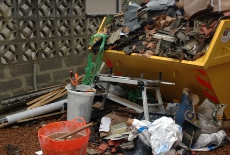 Susan and Paul Collins were left with a skip full of rubbish and building materials when Hughes left.