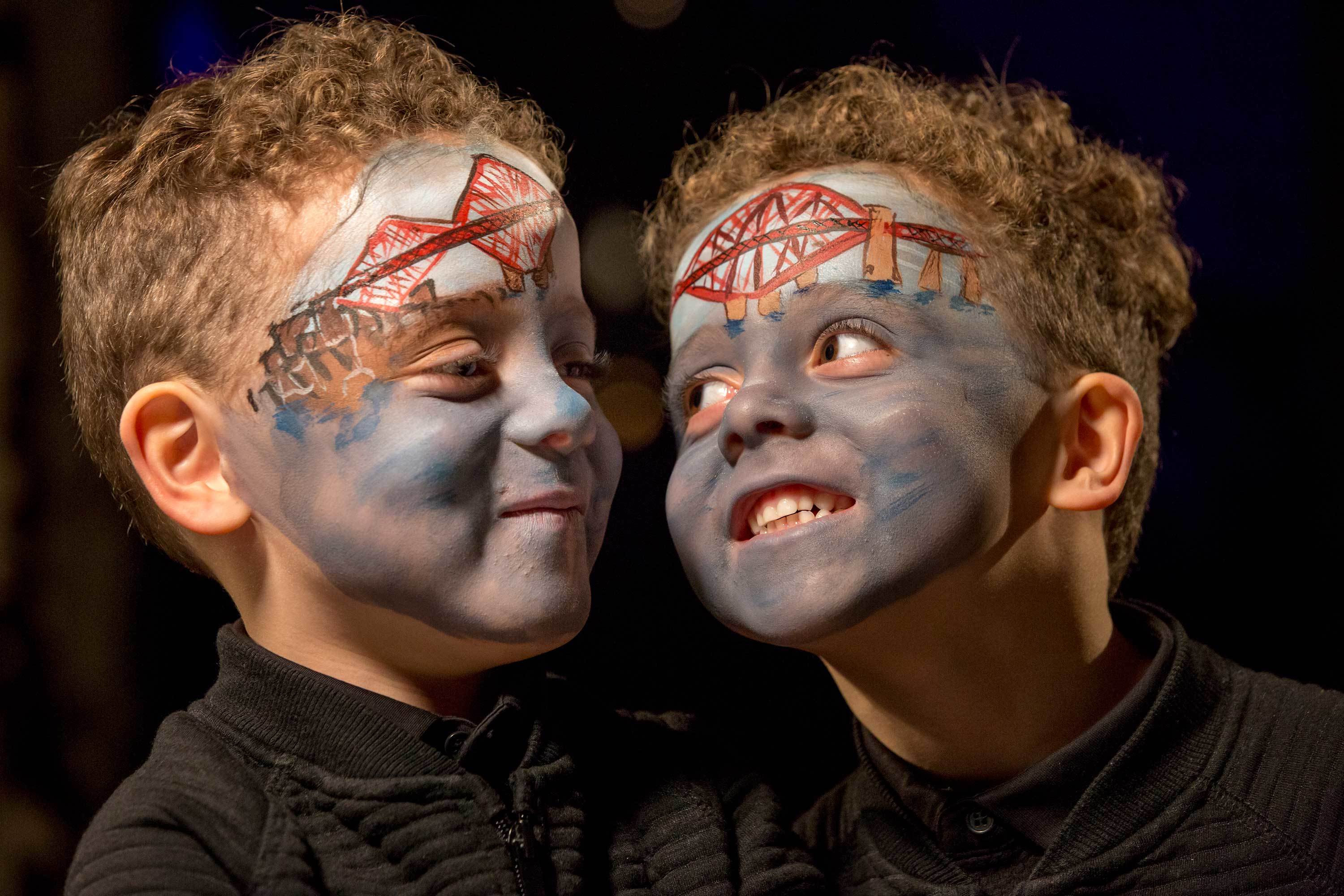 Twin child models Gordon and Jude Lennon wearing face art depicting the Forth Rail Bridge World Heritage Site pose for a portrait at the Real Mary King's Close in Edinburgh.