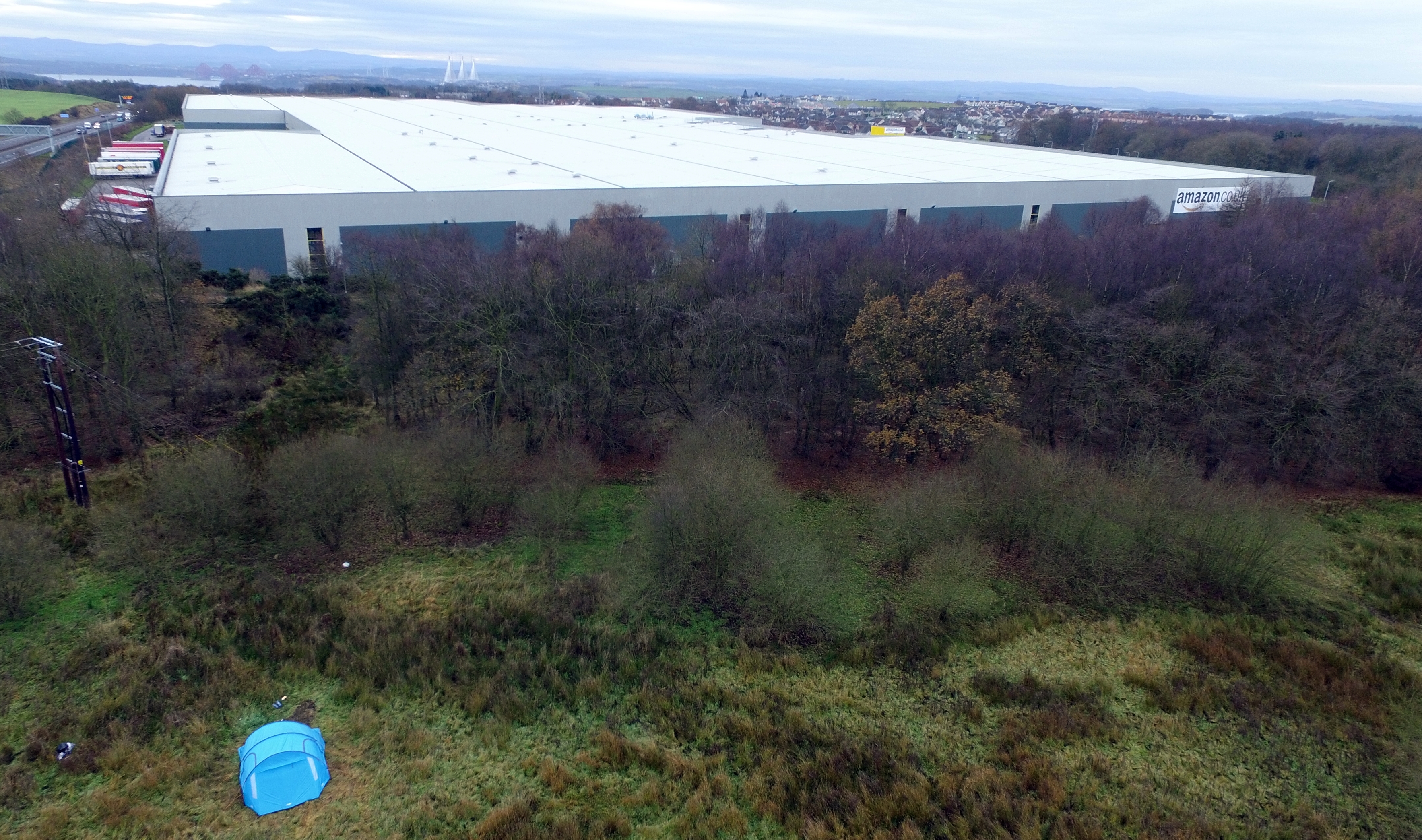 The camper's tent is pitched just a couple of hundred yards from the Amazon fulfilment centre.