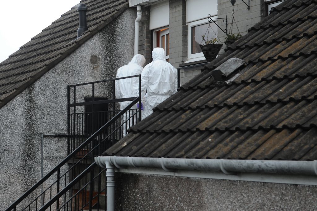 Police investigating at Mary Logie's home after her body was discovered last January.