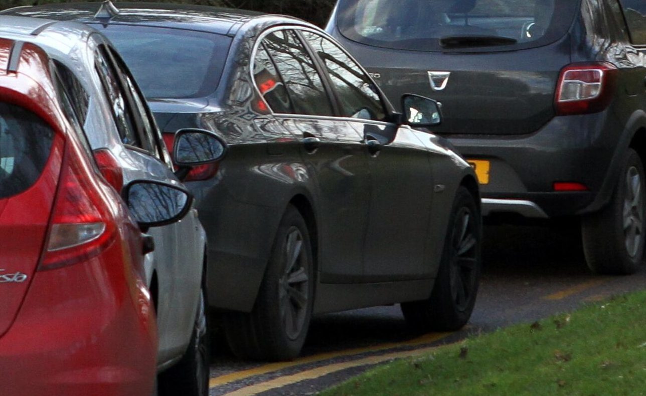 A car parked on double yellow lines.