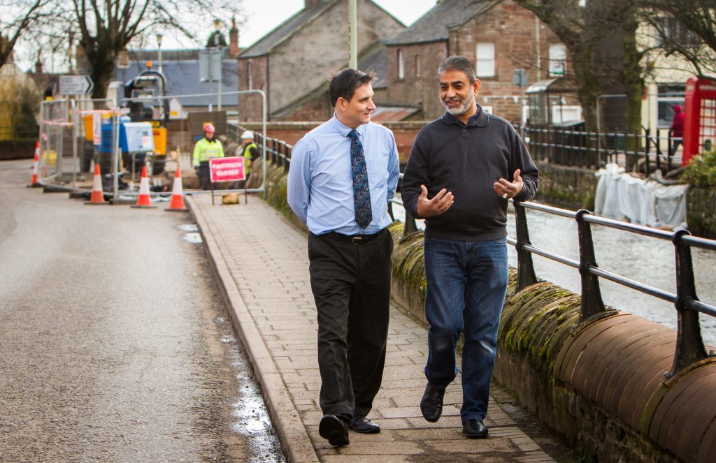 Hotelier David Coupar and shopkeeper Sandy Sarwar discuss the new bridge work.