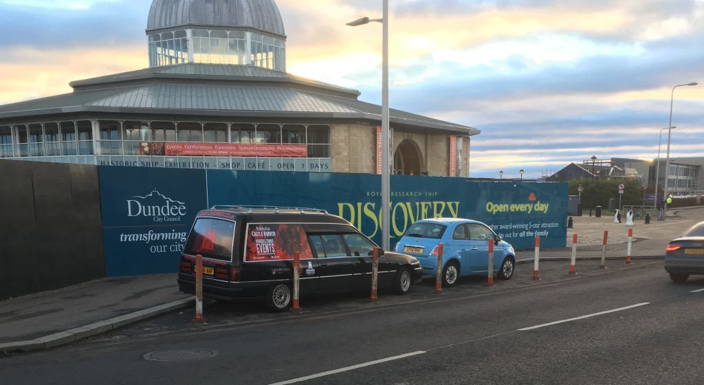 The hearse and Fiat trapped behind the new bollards.