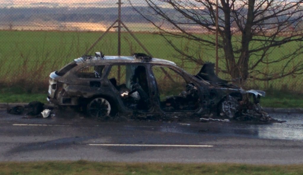 The cindered remains of the police car.