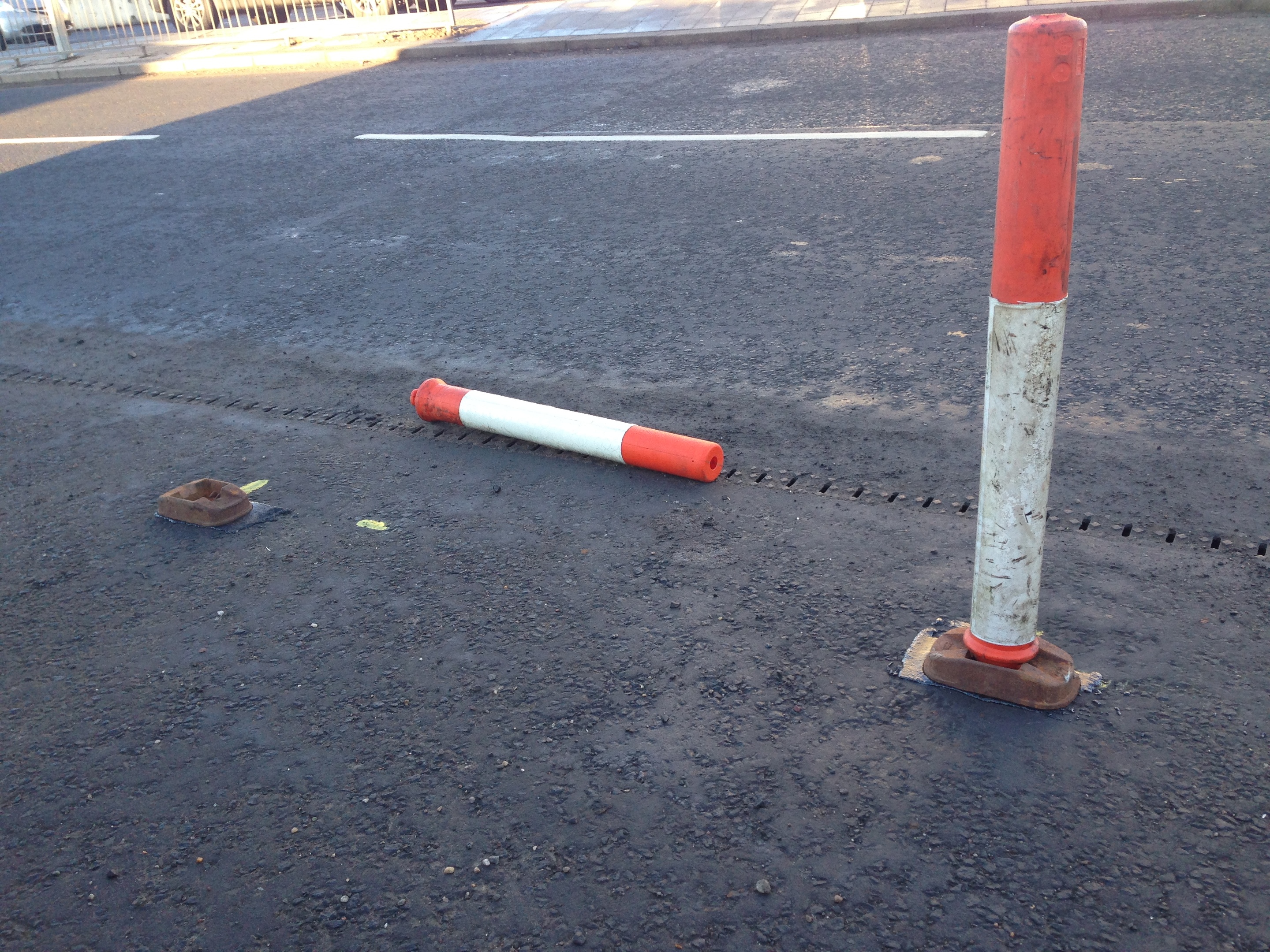 One of the bollards was removed from its base.