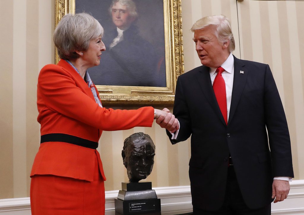 President Donald Trump shakes hands with British Prime Minister Theresa May in the Oval Office of the White House in Washington on January 27