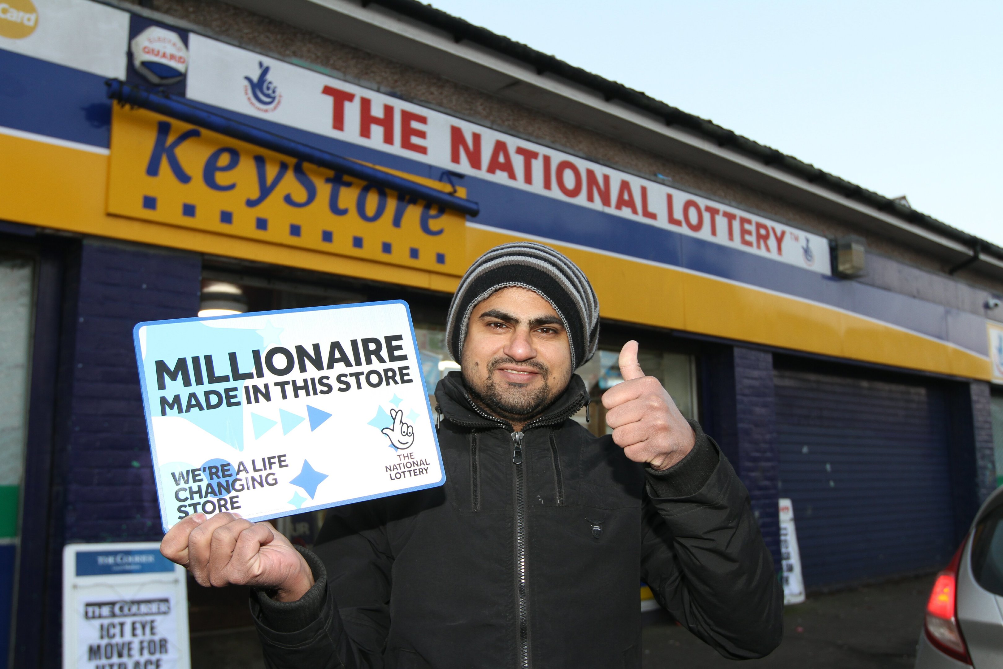 Nasim with the sign on display in his shop.