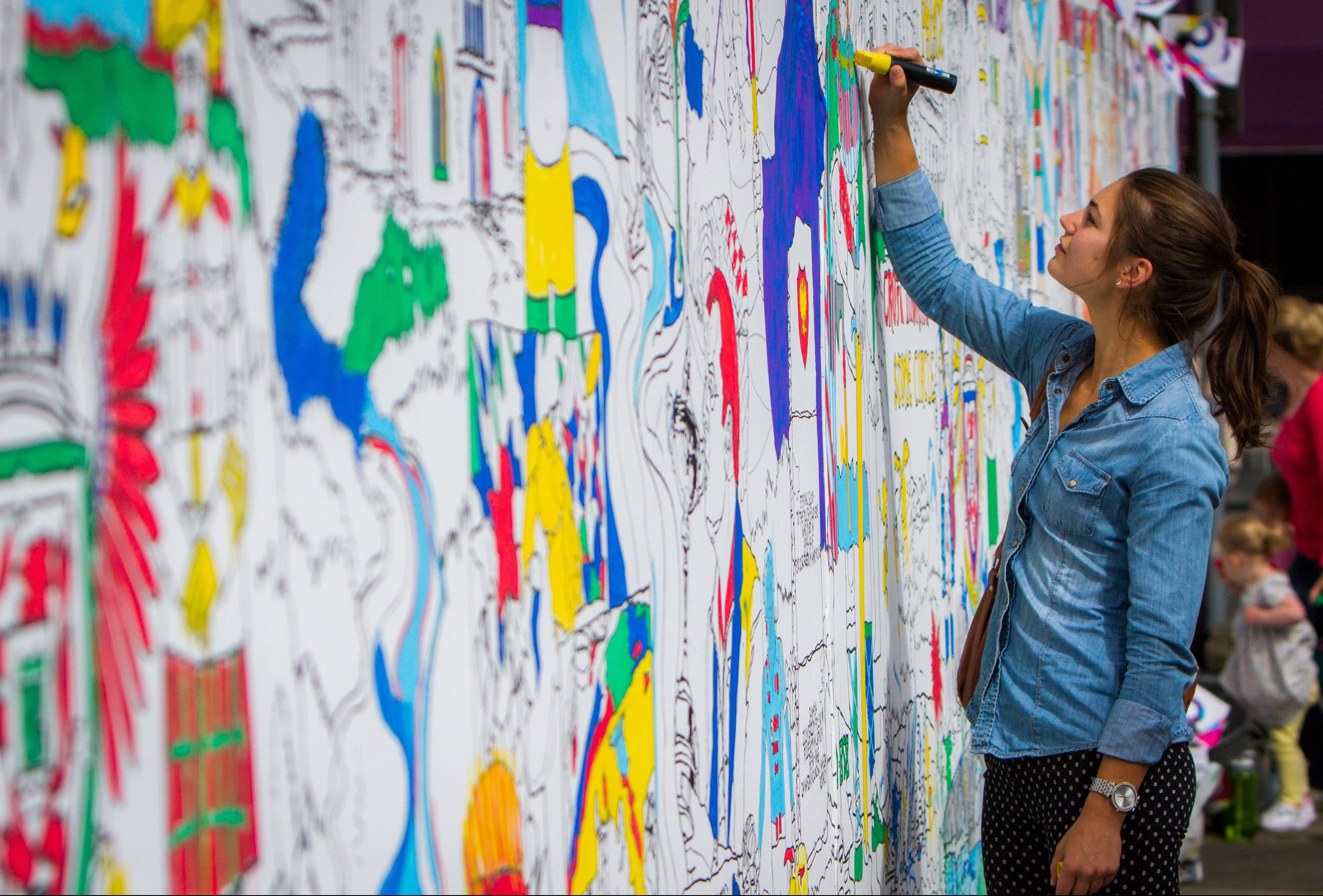 A member of the public signing the Perth City Tapestry, which was part of the City of Culture bid.