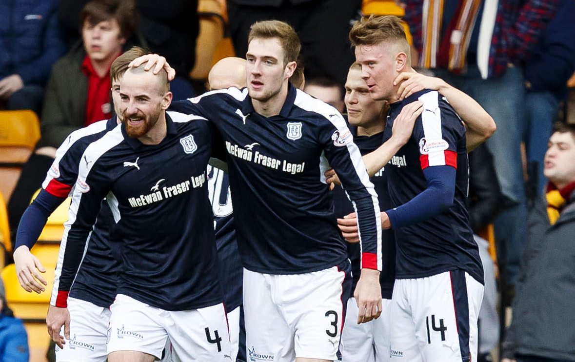 The Dundee players celebrate one of their five first half goals at Motherwell.