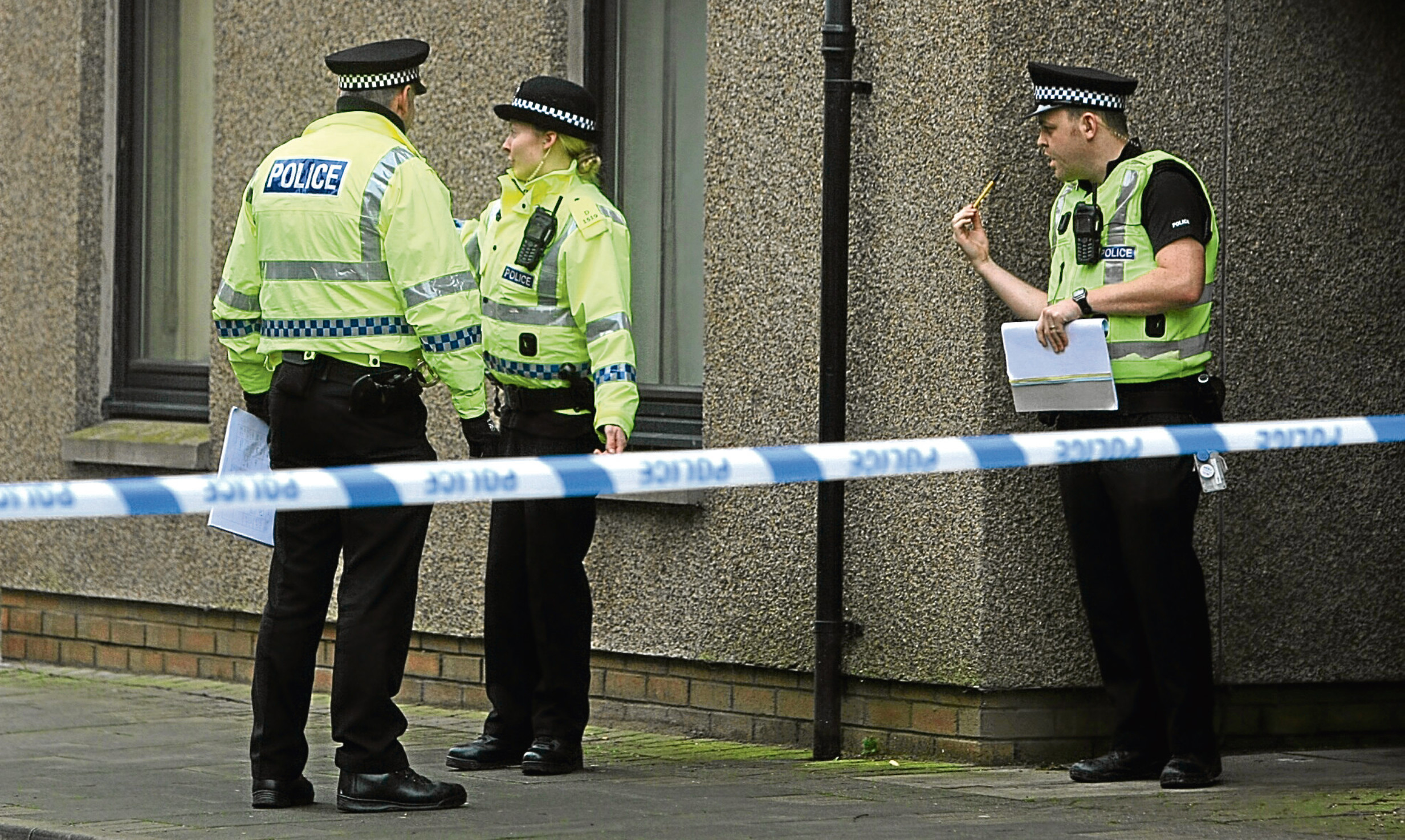 Police officers investigate a murder in Montrose.