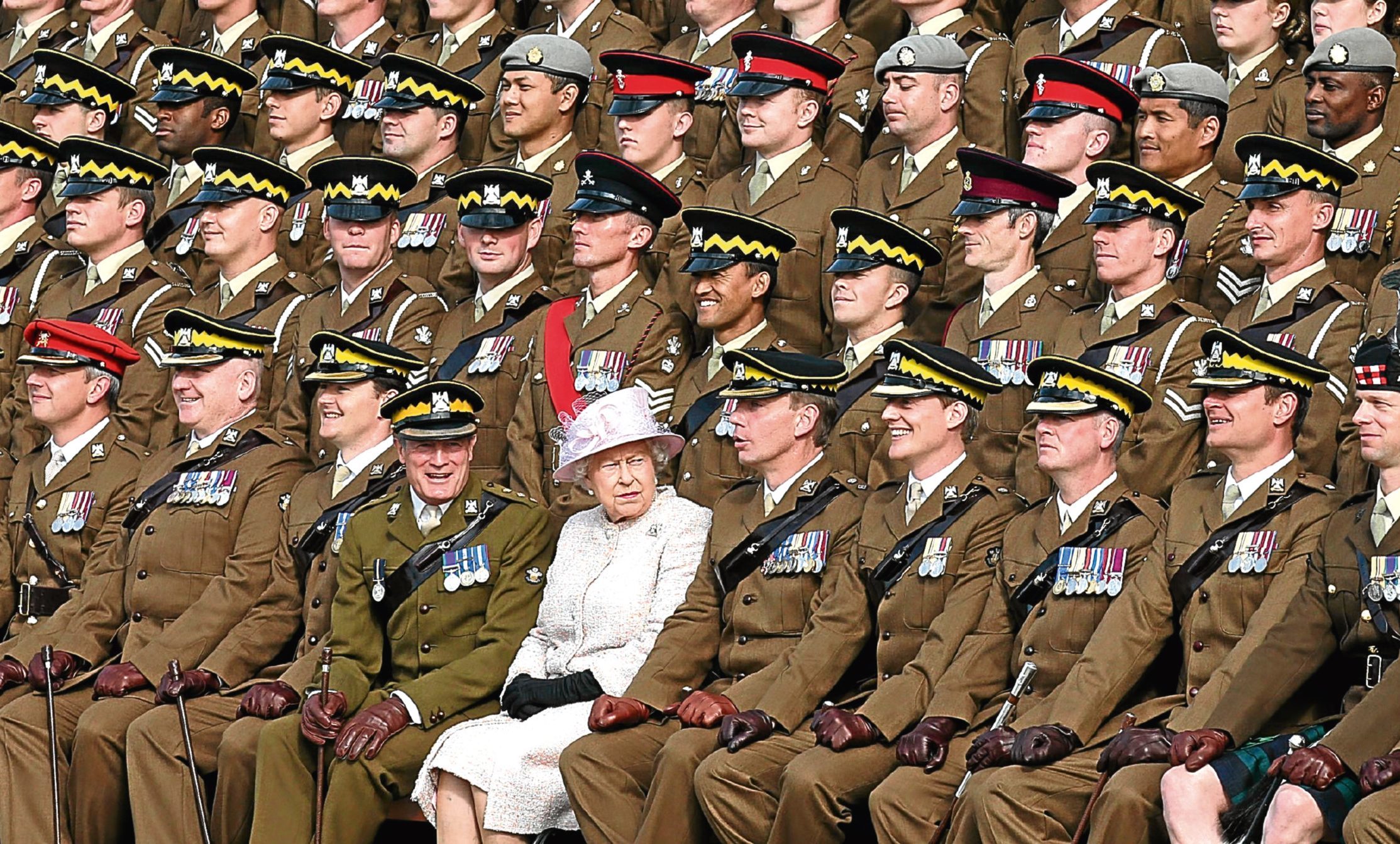 The Queen joins soldiers for a regimental photograph during a visit to the Royal Scots Dragoon Guards at the regiment's new barracks in Leuchars.