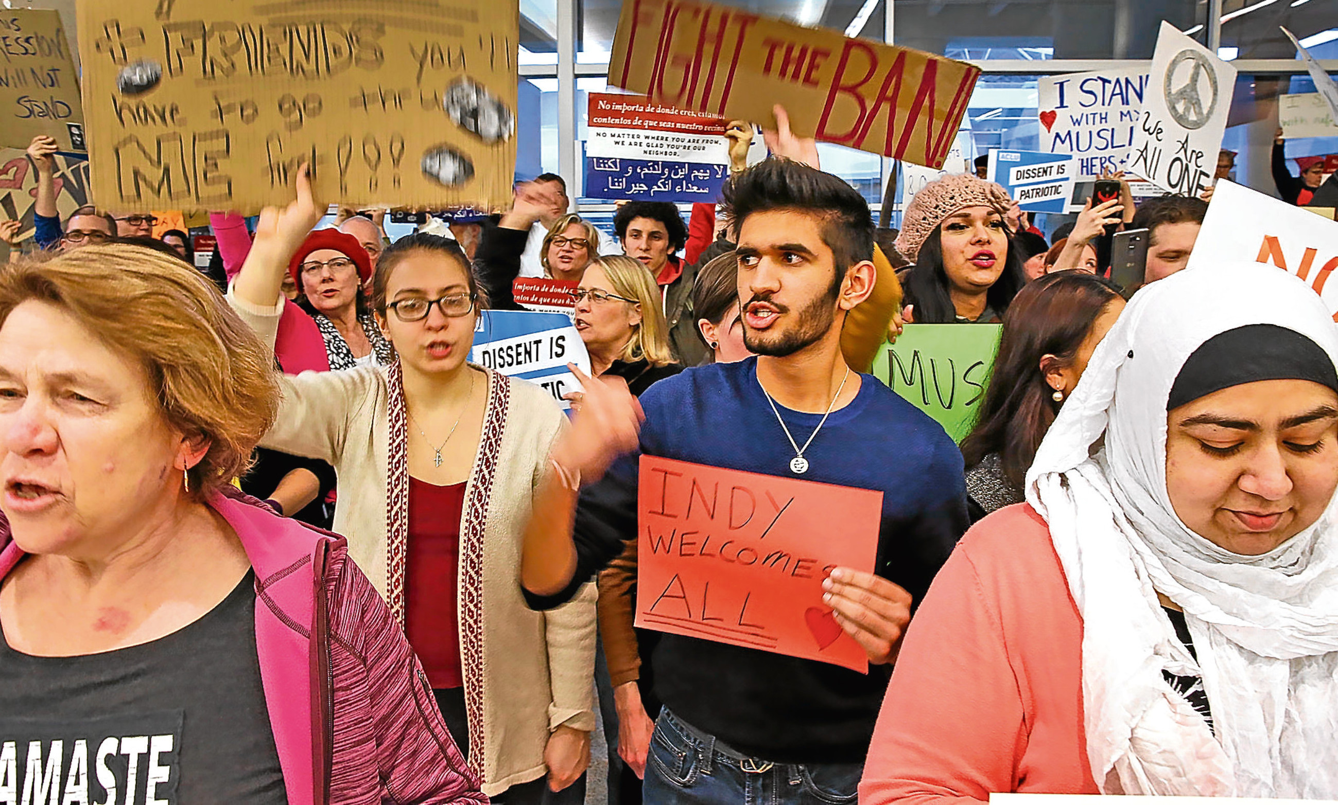 People protest against Donald Trump’s immigration moves at Indianapolis airport.