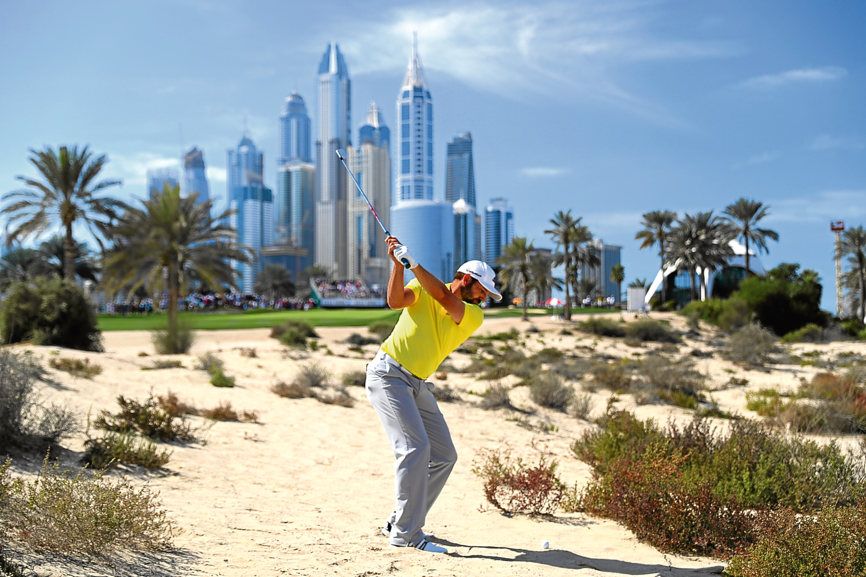 Sergio Garcia visits the desert on his way to winning the Dubai Desert Classic, in his Sunday yellow shirt.