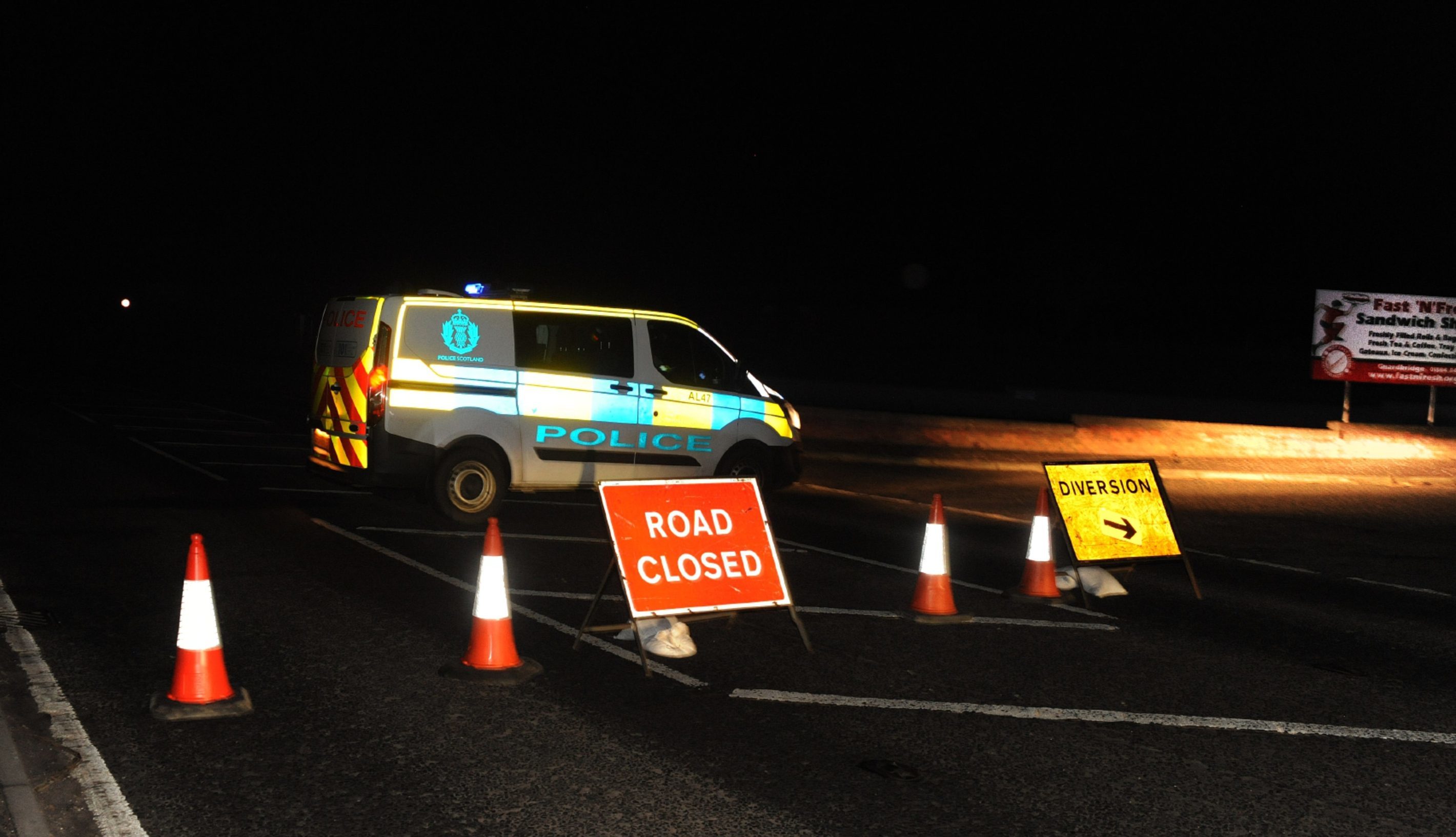 Police close the road outside the Fast and Fresh sandwich bar on the A91 just to the east of Guardbridge.