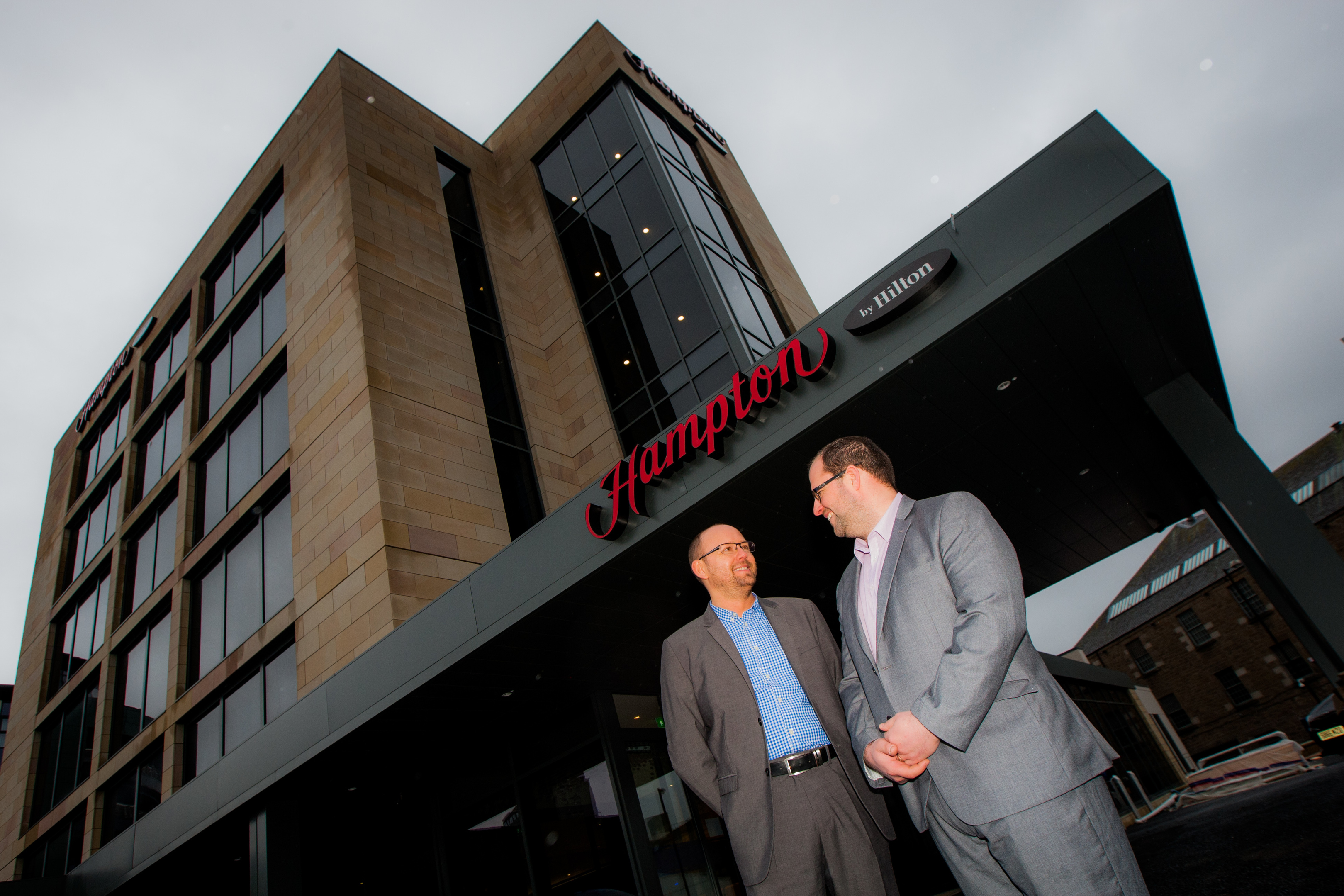 General manager Paul Wood and director of sales Derek Miller in front of the new Hampton by Hilton hotel.