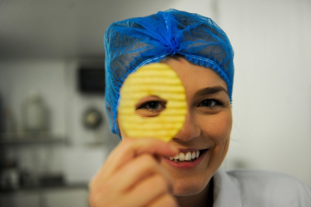 Marketing manager Dani McCann with one of the cored crisps that are assessed in the lab.