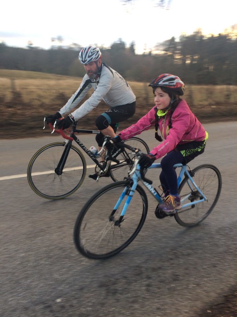 Maisie on her road bike with Scot