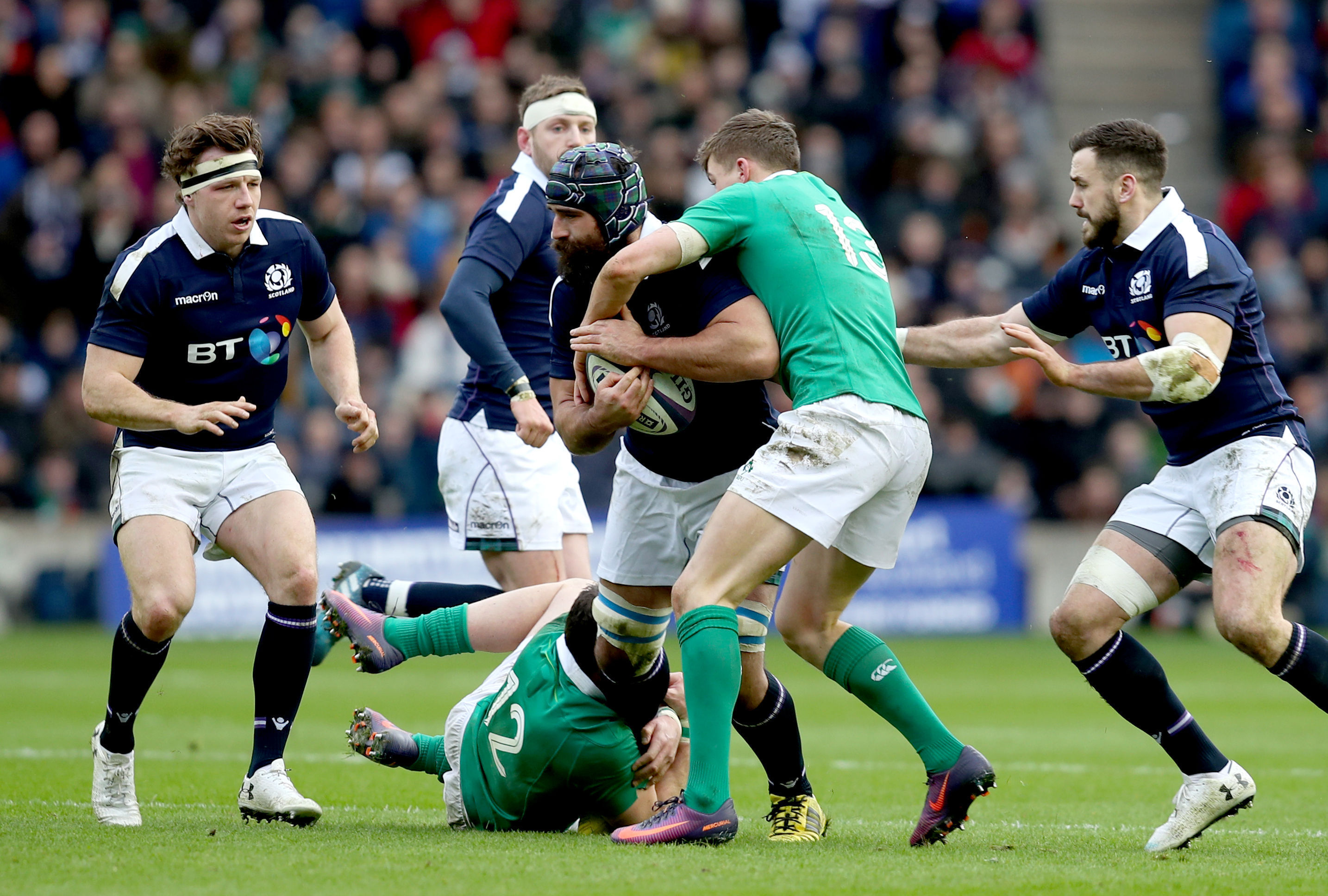 Scotland's Josh Strauss is tackled by Ireland's Garry Ringrose at Murrayfield.